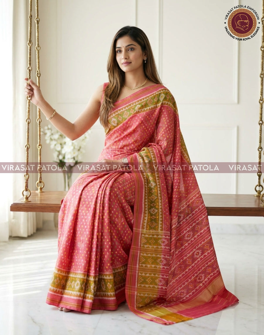 Pink bandhani-style saree with gold and green border, pallu over shoulder