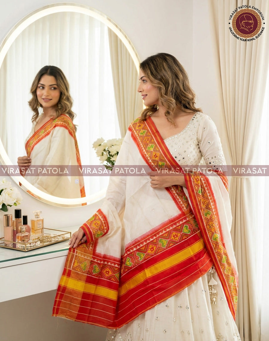 Patola duppatta in orange and white, diagonally draped with geometric border