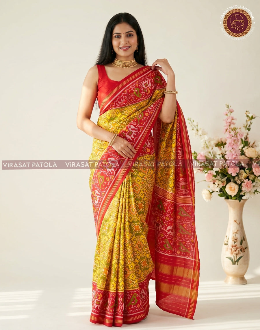 Yellow traditional patola saree with red blouse-style drape and striped gold border