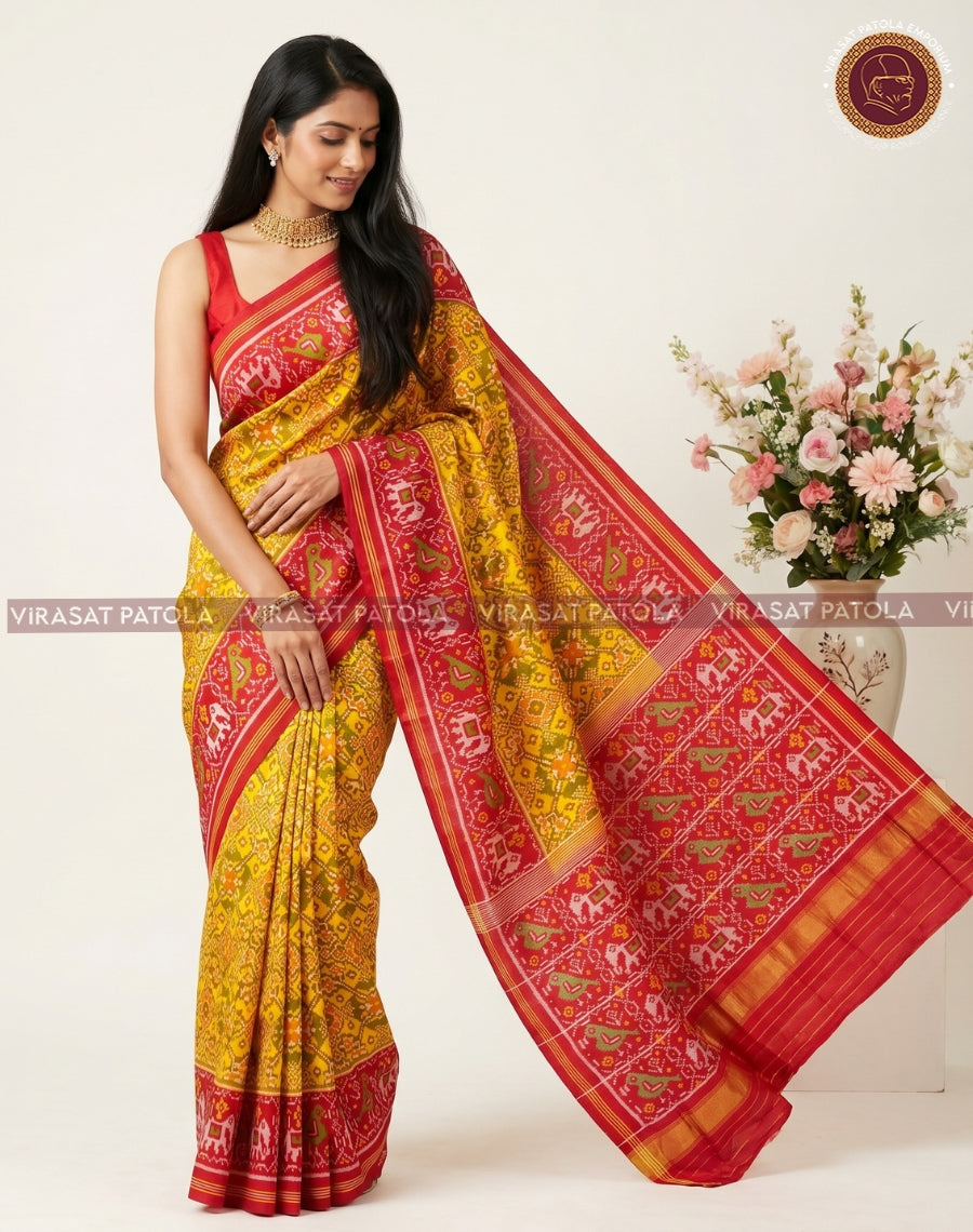 Yellow traditional patola saree with red zari border and intricate woven motifs