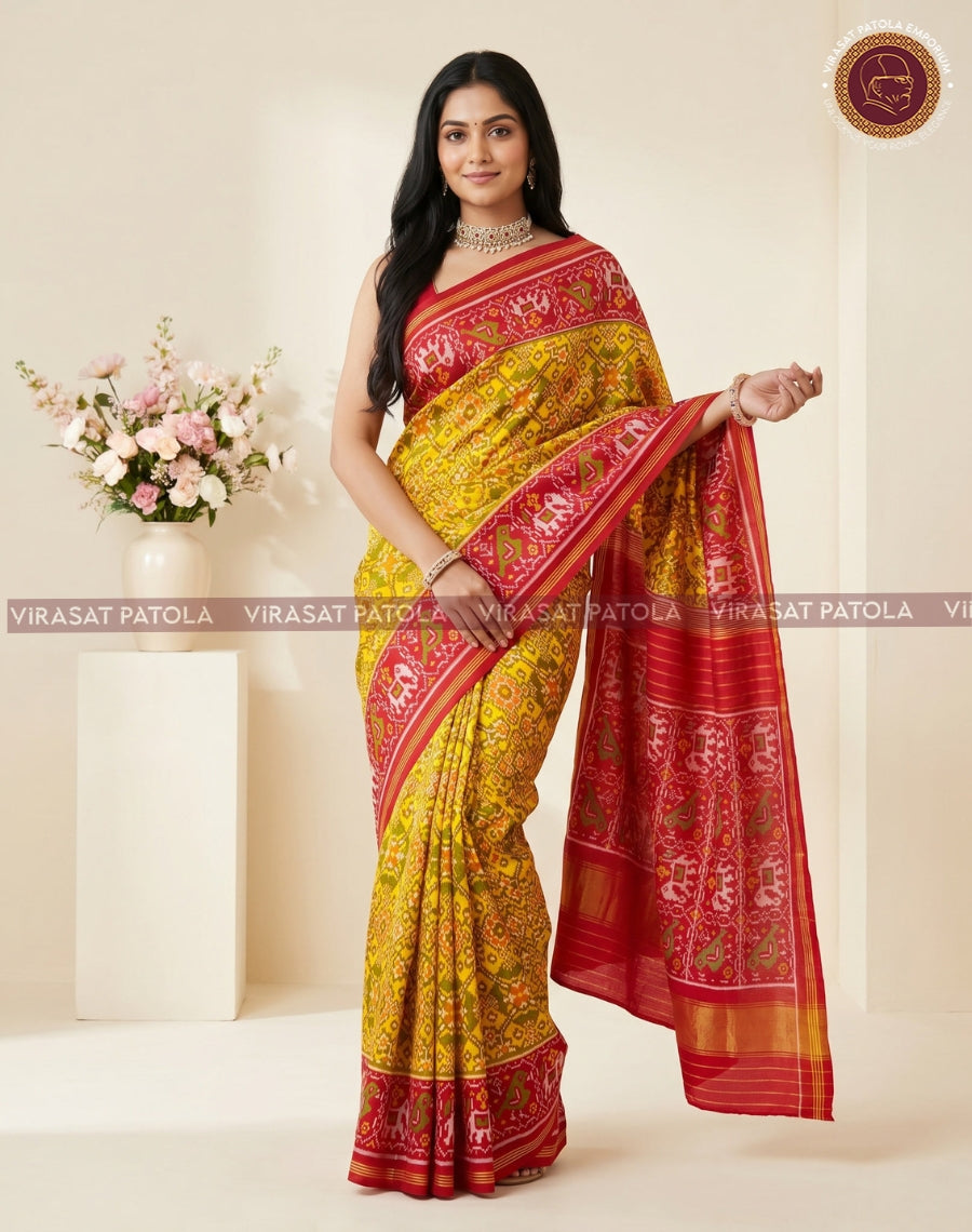 Yellow patola saree with red pallu and detailed woven pattern, wide contrasting border