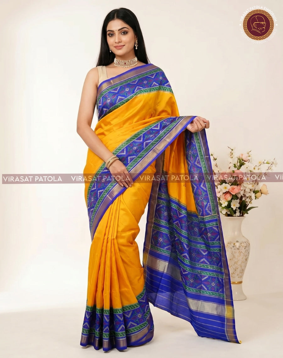 Yellow sari draped with blue pallu featuring geometric patola motifs and border