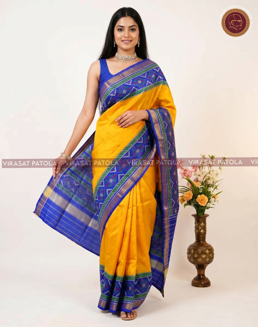 Yellow patola saree with deep blue end border, multicolor accents, and pallu