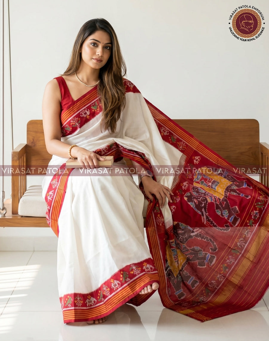 White saree with red and gold-patterned pallu and border, woven motifs