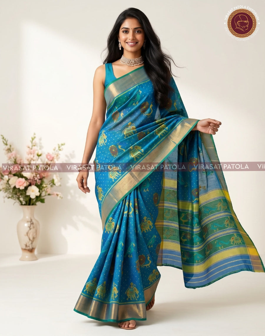 Charcoal blue patola saree with gold animal-style motifs and teal-green zari border