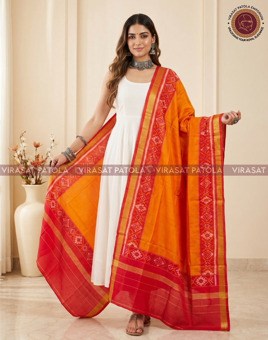 Red and orange patola dupatta with gold borders, diagonally draped over a dress