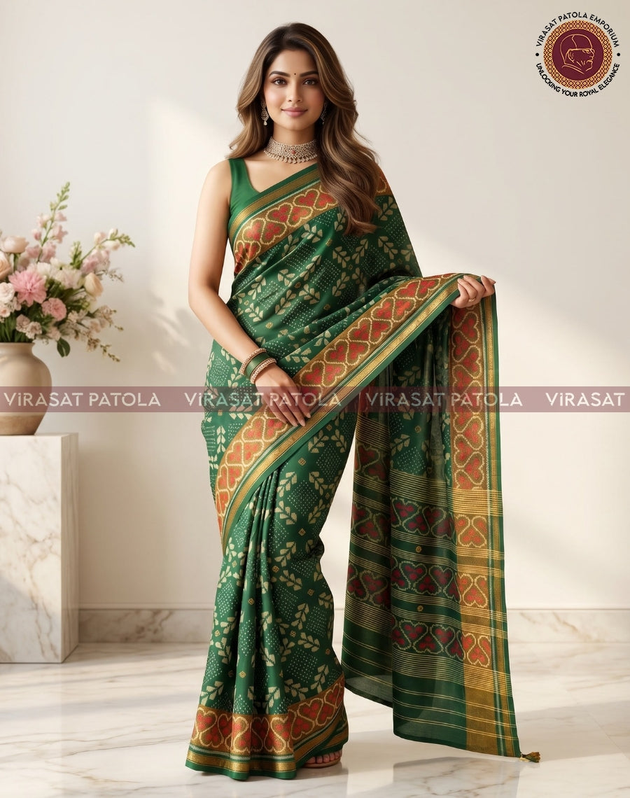 Green patola saree with wide red-gold pallu border and small dotted motifs