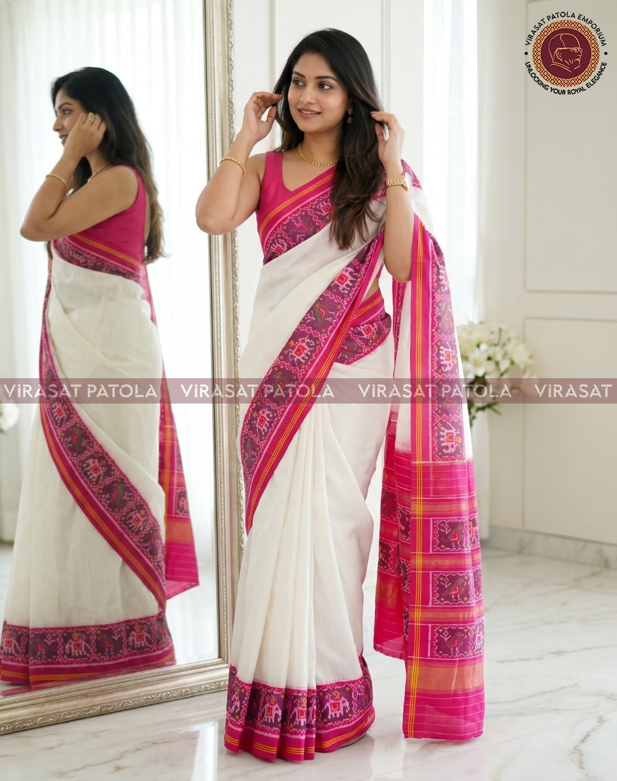 White saree with magenta border, geometric motifs, and draped pallu detail
