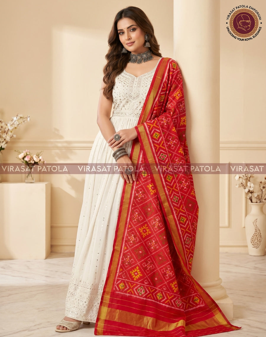 Red patola dupatta draped on the shoulder with gold trim and motifs