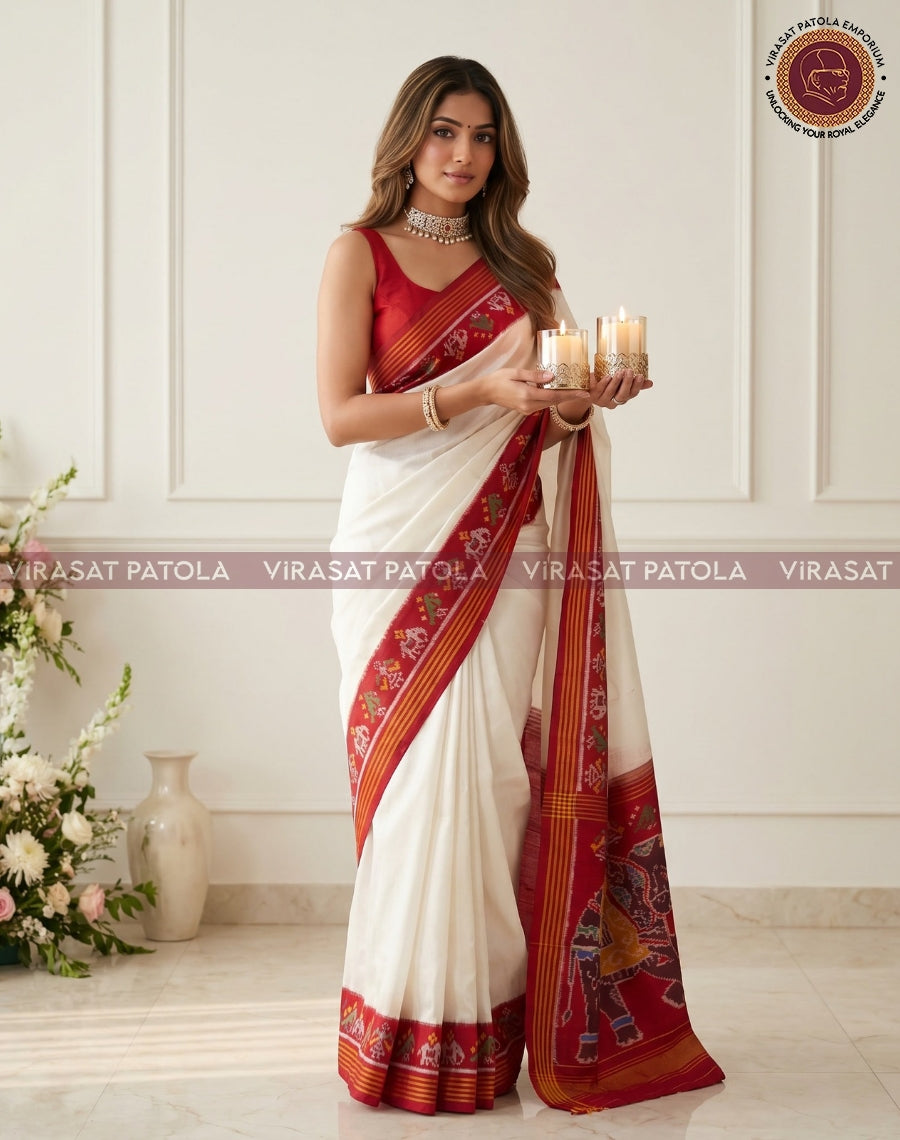 Traditional saree in white with red patterned border and pallu